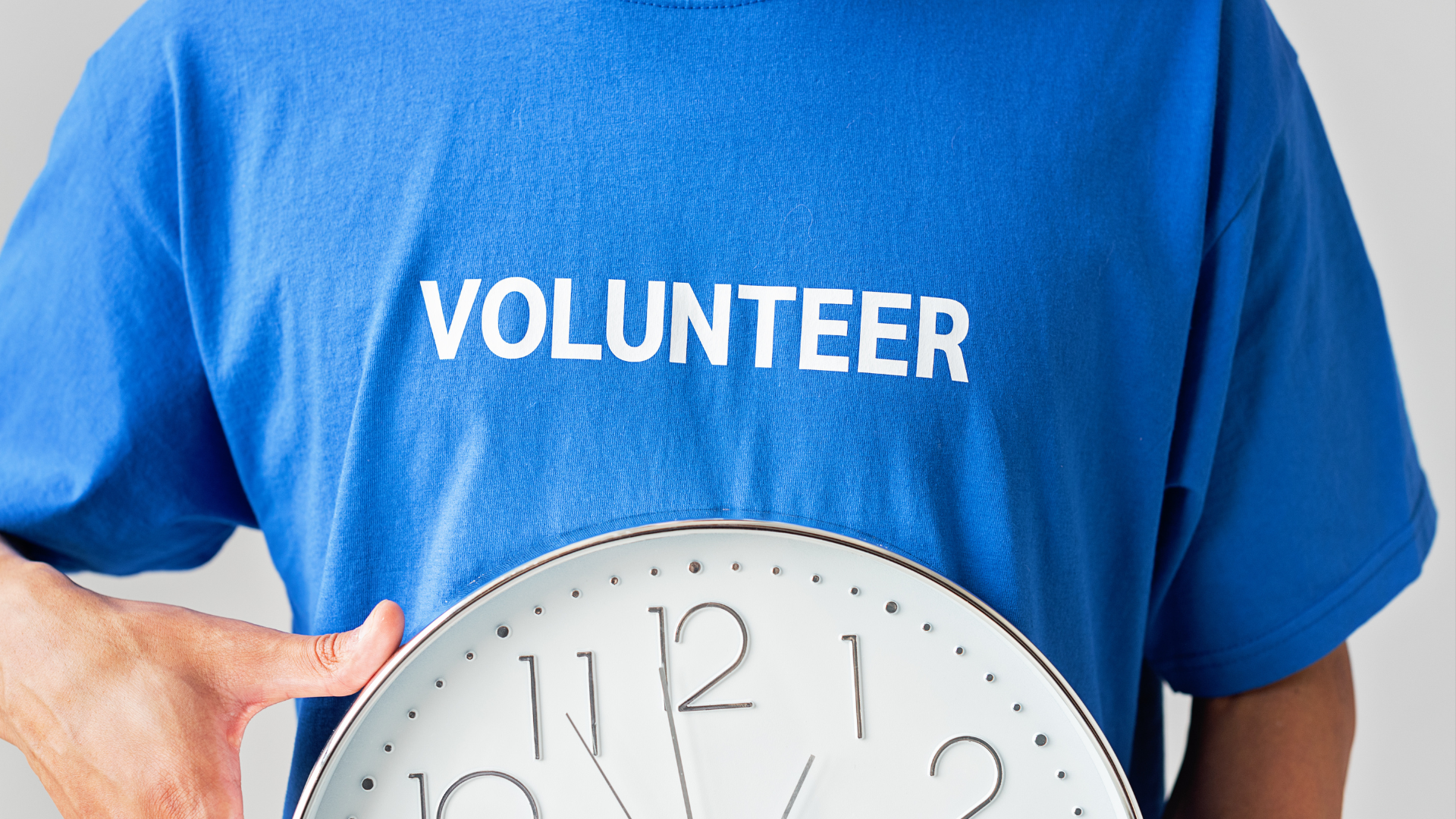 Man with Voluteer T-shirt and clock.png